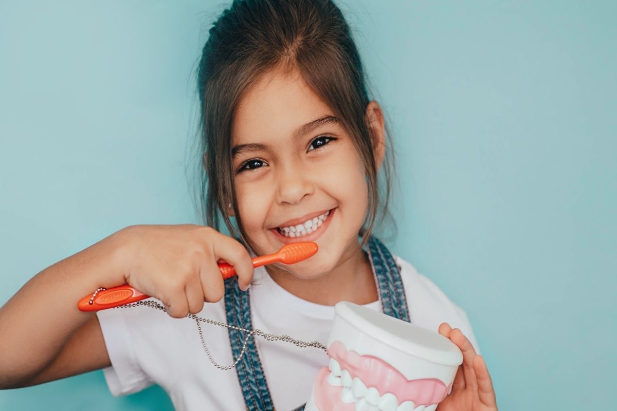 Happy child showing her new smile after cosmetic dental treatment in Carrollton.